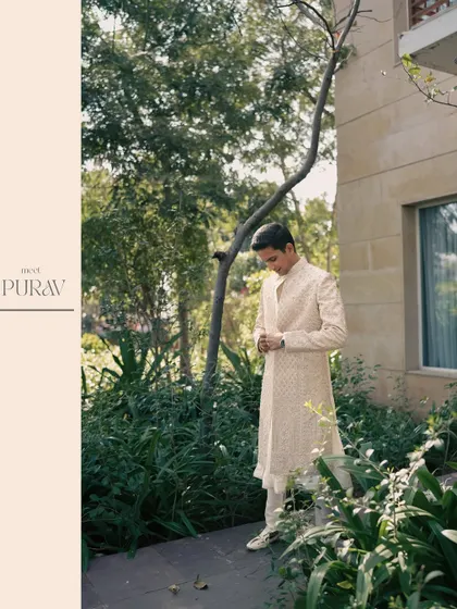 A stylish portrait of the groom, getting ready in a garden setting, capturing a moment of quiet anticipation before the celebrations begin.