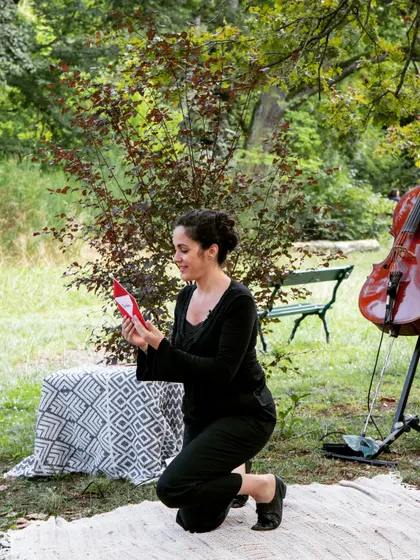 An artist interacts with a small prop during the performance. Every detail in 'Pajarillo Verde' is crafted to create a whimsical and engaging world for our young audience.