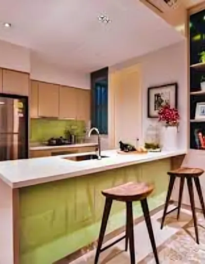 This kitchen features a bright green island with a white countertop that serves as a breakfast nook. It's a great way to add a pop of color and create a casual dining spot.