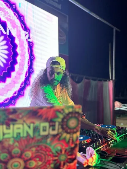 On stage at the Panoor Fest, with a vibrant psychedelic graphic on the LED screen behind me.