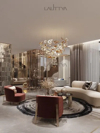 This living space is a study in contemporary elegance, where a curved sofa and bold red armchairs create a dynamic seating arrangement. The room is unified by a neutral color palette, rich textures, and sculptural lighting, with a glass partition offering a glimpse into the adjoining areas.