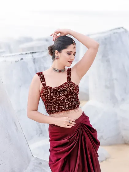 A beachside fashion shoot for a designer's modern-ethnic collection. The models are posed against the sea and coastal rocks to create a windswept, editorial feel that highlights the clothing.