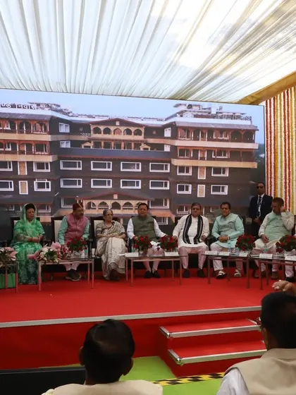 Another view from the stage at the Uttarakhand Niwas inauguration, with the building's beautiful facade displayed on the screen behind the dignitaries. A proud day for our entire team.