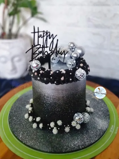 It's time to disco! This black and silver ombre cake is ready for a party, decorated with mini disco balls and sparkling edible glitter.