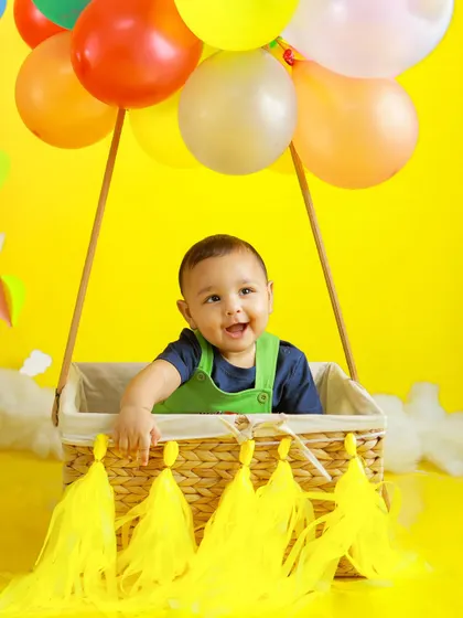 Up, up, and away. This hot air balloon setup is a popular choice for sitter sessions. This little boy's happy smile shows how much fun these imaginative shoots can be.