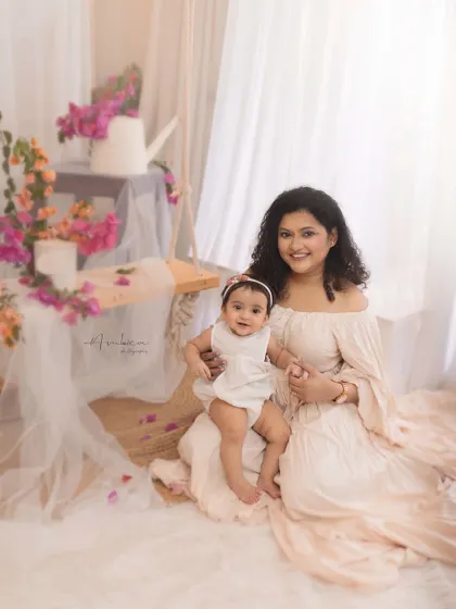 A serene portrait of a mother and her baby girl in our spring-themed setup. The light and airy feel of the scene perfectly complements their gentle bond.