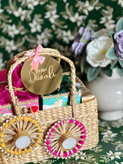 A unique Diwali basket featuring plantable crackers, pichwai potli boxes, and decorative tea light holders.