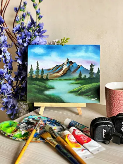 My mini mountain landscape painting, set up in my workspace. It shows how even a small canvas can hold a grand vision.