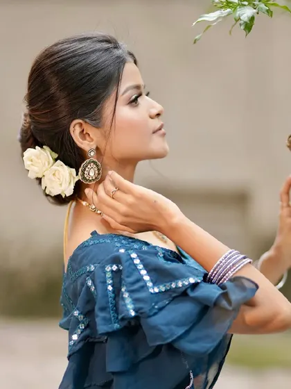 Another angle of this soft and sophisticated look. The floral bun and simple makeup create a timeless and elegant feel.