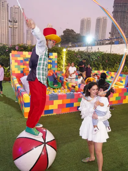 A stilt-walker entertains guests, adding to the lively and interactive atmosphere of our outdoor circus-themed party.