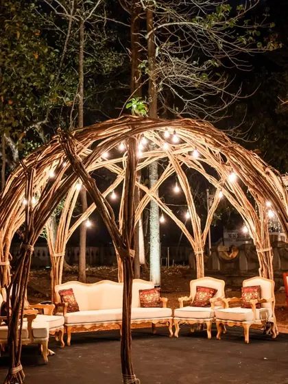 A rustic yet elegant seating dome made of woven branches and lit with Edison bulbs. This created a cozy and whimsical lounge area for guests to relax in during the evening.