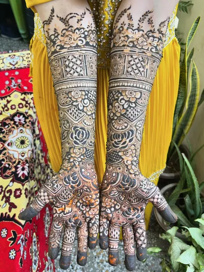A gorgeous bridal design with a mix of floral and geometric patterns. The contrast between the light and dark elements makes the design pop.