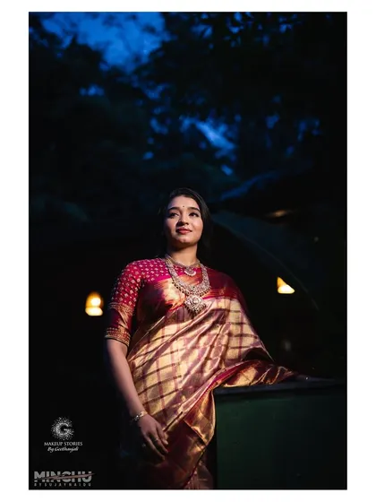 A dramatic portrait of Priyanka at her post wedding reception. The makeup is designed to look stunning in low light, with a focus on luminous skin and defined features.