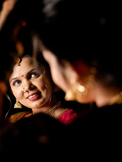 A creative shot looking up at the bride's reflection, capturing her joyful expression from a unique perspective.