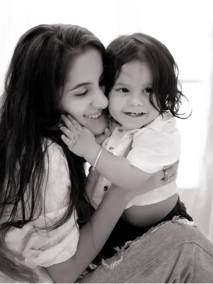 A black and white version of a tender mother and son portrait, emphasizing the emotional connection and loving embrace.