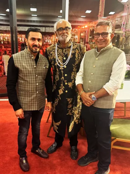 Our founder, Mr. Rajesh Lakhani, and director, Mr. Dewang Lakhani, with esteemed client Savji Bhai Dholakia at a grand wedding in Surat. This photo represents the strong relationships we build with our clients.