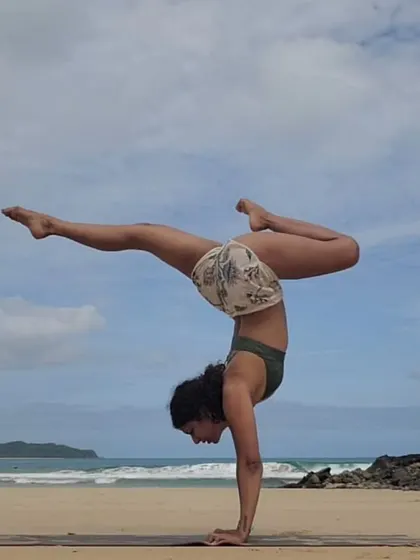 Celebrating Dussehra with a handstand on the beach. This pose reflects the balance and strength needed to overcome our inner demons and let the light shine through.