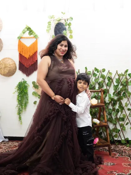 A lovely family moment during a maternity shoot. Our brown ruffle gown is an elegant and unique choice for your special photos.