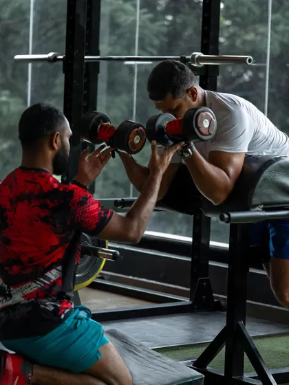 Correcting form on a preacher curl, because even smaller muscle groups require precise technique to prevent elbow and bicep injuries.