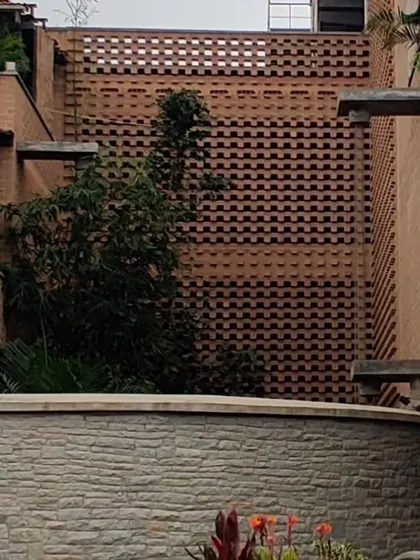 A detail of the brick screen wall, a key feature of the hotel's bioclimatic design that helps in passive cooling.