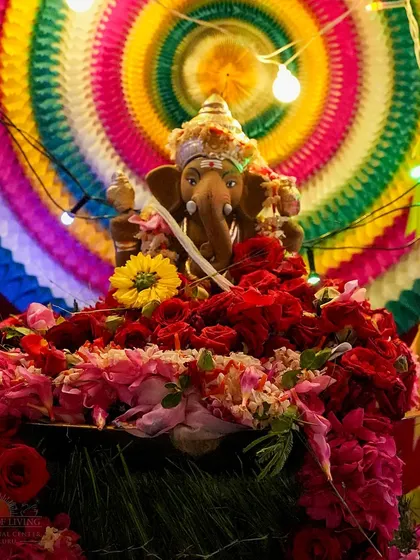 A vibrant, eco-friendly Ganesha idol surrounded by flowers and colorful paper decorations. Our celebrations emphasize creativity and respect for nature.
