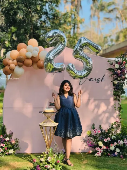 Varsh celebrating her 25th birthday in a beautiful garden setting. We created a soft pink backdrop adorned with fresh flowers and a pastel balloon arrangement for an elegant and feminine touch.
