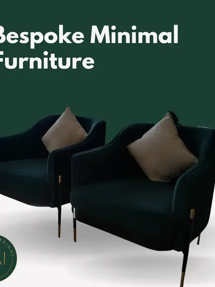 A pair of deep green velvet armchairs with slender metal legs. These chairs were designed to offer a touch of minimalist luxury and are perfect for a modern office reception or a chic living room.