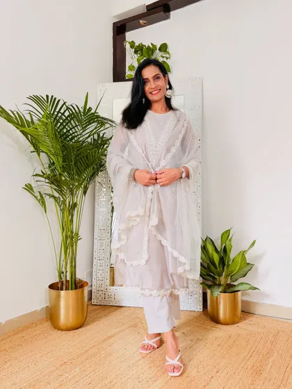 This white-on-white layered suit is the epitome of grace. It's a very sophisticated and understated festive look.