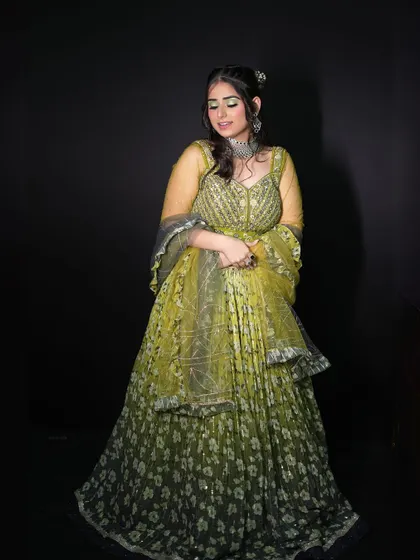 A full-length view of our green and yellow floral lehenga, a fresh and vibrant choice for a mehendi or sangeet.