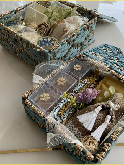 An inside look at the blue jute hamper, revealing a curated selection of gifts. The woven texture and color provide a beautiful backdrop for the items within.