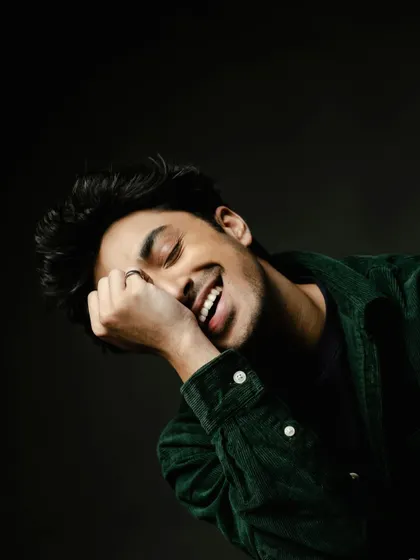 A candid, happy moment from a shoot with Lakshya. Here he wears a dark green corduroy jacket, showing a more casual and textured side of men's styling.