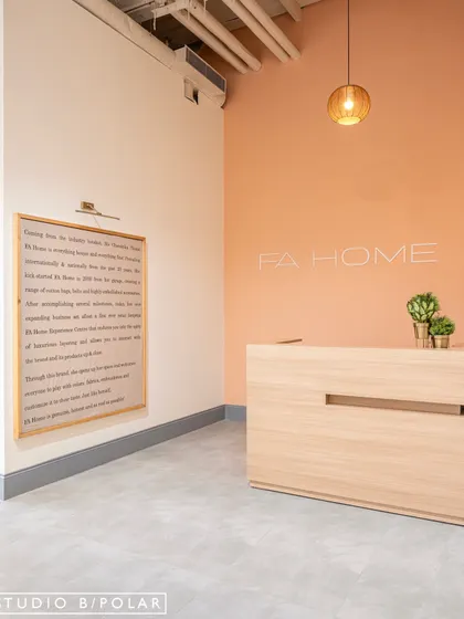 A closer look at the welcoming reception desk and the brand story wall. The design is intentionally restrained to let the brand's identity and products speak for themselves, creating a sophisticated first impression.