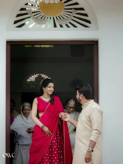 A lovely moment as the groom-to-be welcomes his partner, with family looking on, blending pre-wedding vibes with family warmth.