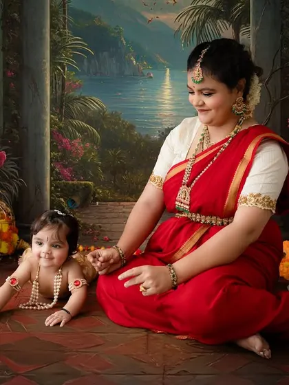 A playful moment on the floor, with the mother and her crawling baby Krishna sharing a smile.