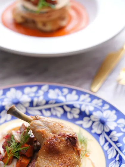 A close-up of my duck confit, showcasing the crispy skin and tender meat.