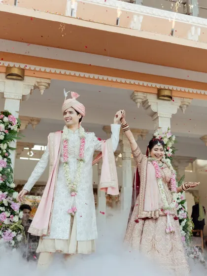 The grand finale of a beautiful wedding in Udaipur, with the couple celebrating their union amidst smoke effects. A testament to capturing spectacular moments in royal settings.