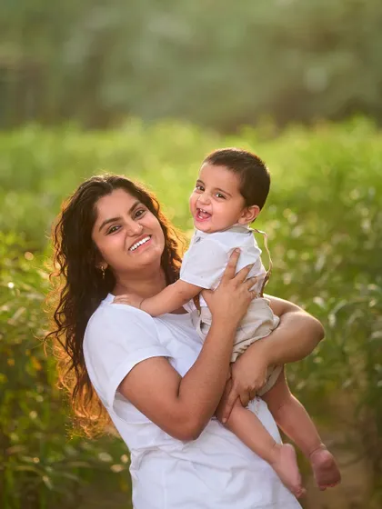 The pure happiness of a mother and her child. The golden hour light in this outdoor family photoshoot adds a warm, magical glow to this beautiful moment.