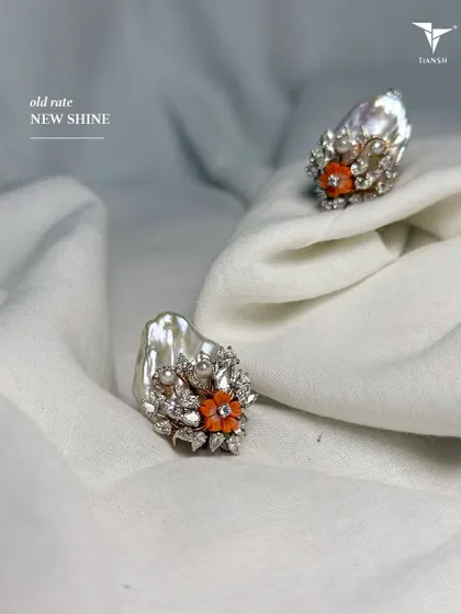When pearls meet colored stones, it creates magic. These unique baroque pearl and coral floral earrings are now available at the old gold rate. Visit me to see many more such pieces.