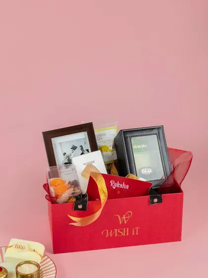 Our Rakhi hamper for brothers, "The Bro Bond Box". It includes a watch box, a photo frame, snacks, and other goodies for your partner-in-crime.