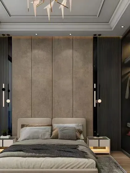 A luxurious bedroom featuring a floor-to-ceiling upholstered headboard and smoked glass wardrobe doors. The recessed lighting and elegant wall sconces add to the sophisticated ambiance.