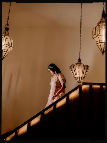 Duplicate of image 390, a shot of the bride on the stairs.
