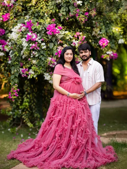 A classic couple's portrait surrounded by vibrant bougainvillea. The natural flowers provide a beautiful and colorful frame for this happy moment.