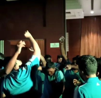 The ABB team with their hands in the air, celebrating together. It was a night of pure fun and team bonding.