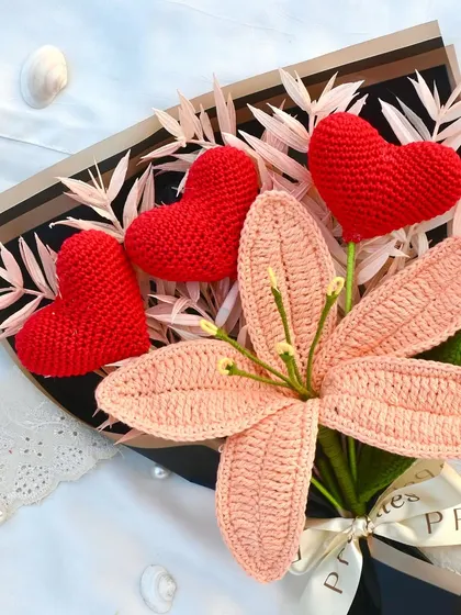 A close-up of our "Cherry Blossom" bouquet, showing the detail of the handmade lily and crochet hearts.