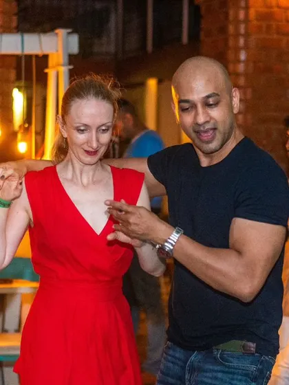 A beautiful moment of connection during a Bachata dance. The warm lighting and great music create the perfect atmosphere.