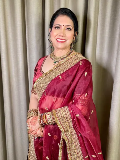 A beautiful portrait of the mother of the bride. Her smile says it all! The makeup is designed to make her feel confident and beautiful on her daughter's big day.