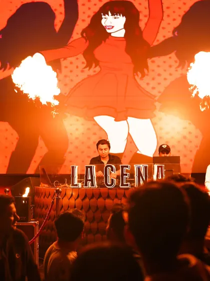 A dramatic shot from my set at La Cena, with fire effects framing the DJ booth. I love performing at venues that go all-in on the visual experience.