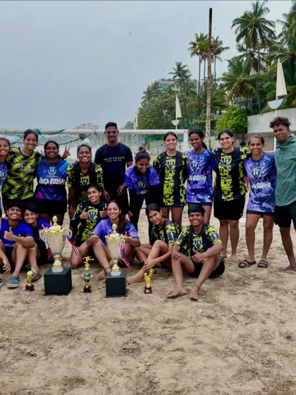 A candid shot of our team celebrating on the beach with multiple trophies, a perfect end to a successful tournament.