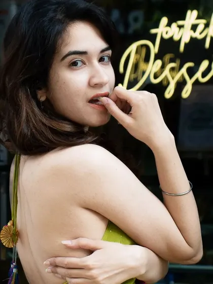 A playful and alluring portrait with a neon sign in the background. Using elements of the location's decor, like this sign, adds character and context to the photos.