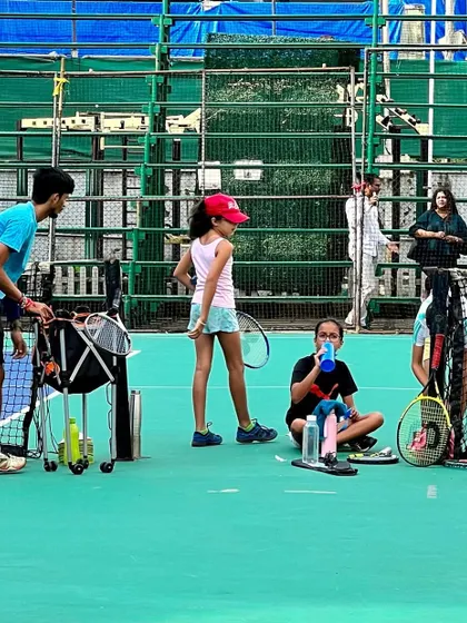 Players taking a well-deserved break in the shade. We ensure our sessions are balanced with adequate rest, allowing our athletes to recover and maintain their energy levels throughout practice.